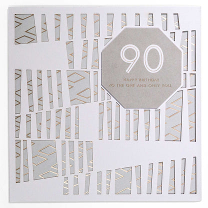 Contemporary Gold 90th Birthday Card with laser-cut design, geometric details, and gold foil highlights, flat lay view.